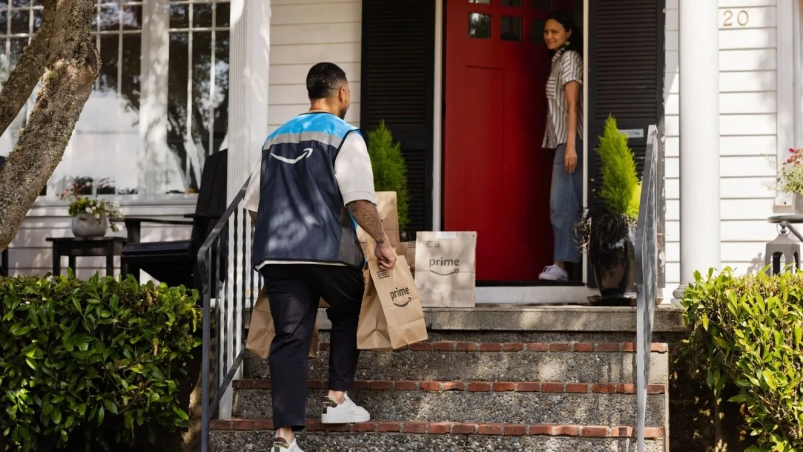 Delivery person brings packages to doorstep