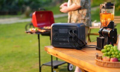 Portable generator on outdoor table for backyard barbecue.