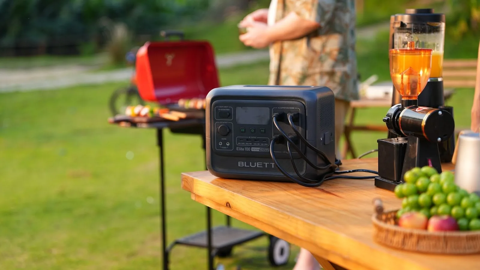 Portable generator on outdoor table for backyard barbecue.