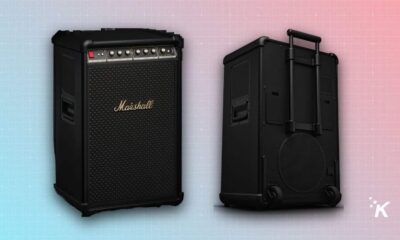 Black portable guitar amplifier with handle and wheels.