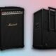 Black portable guitar amplifier with handle and wheels.
