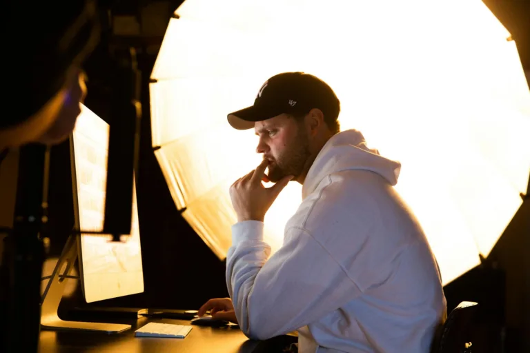 Man thinking while working at computer with backlight.
