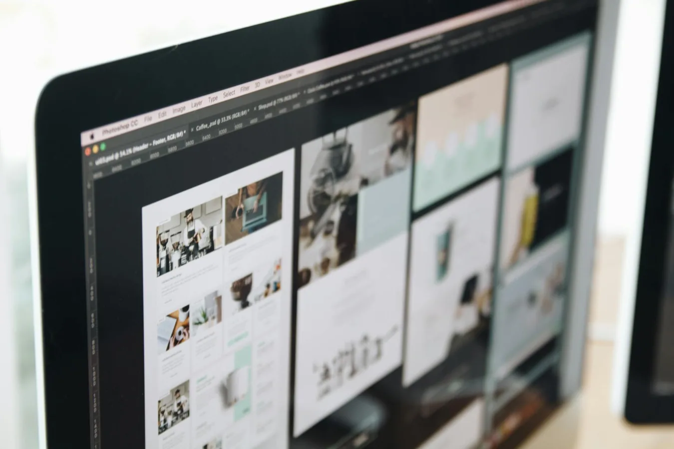 Computer screen displaying web design mockups.