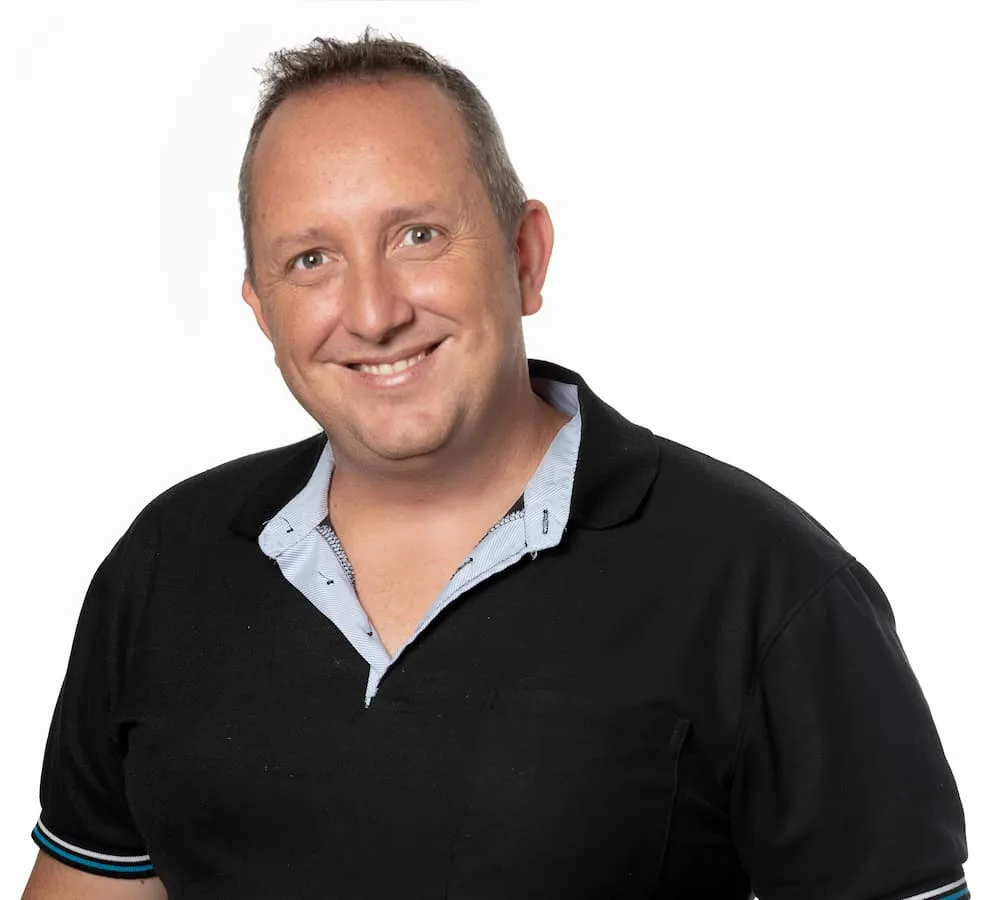 Smiling person in a black shirt.