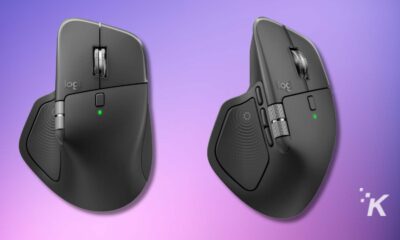 Wireless ergonomic computer mouse with adjustable buttons and thumb rest against purple background.