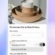 Minimalist ceramic dinnerware set with bowls, plates, and a mug on a white surface with a blurred background.