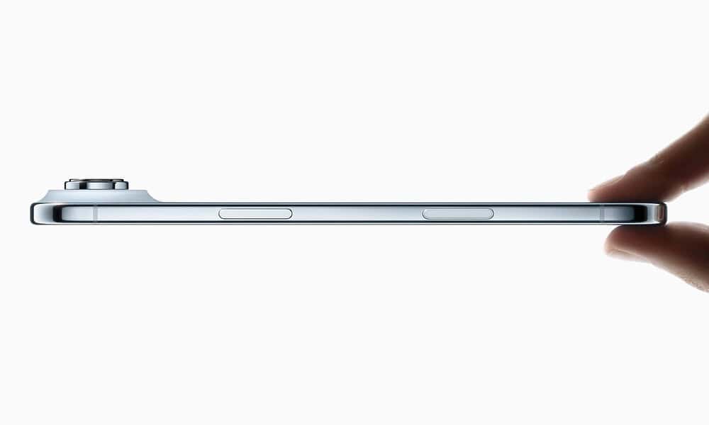 Side view of thin smartphone held with fingers.