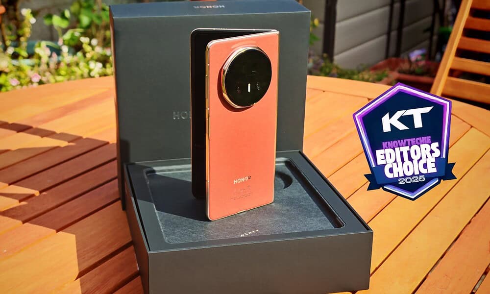 High-end Honor smartphone with a distinctive circular camera module, presented outdoors on a wooden table, showcasing innovative mobile device design and cutting-edge technology.