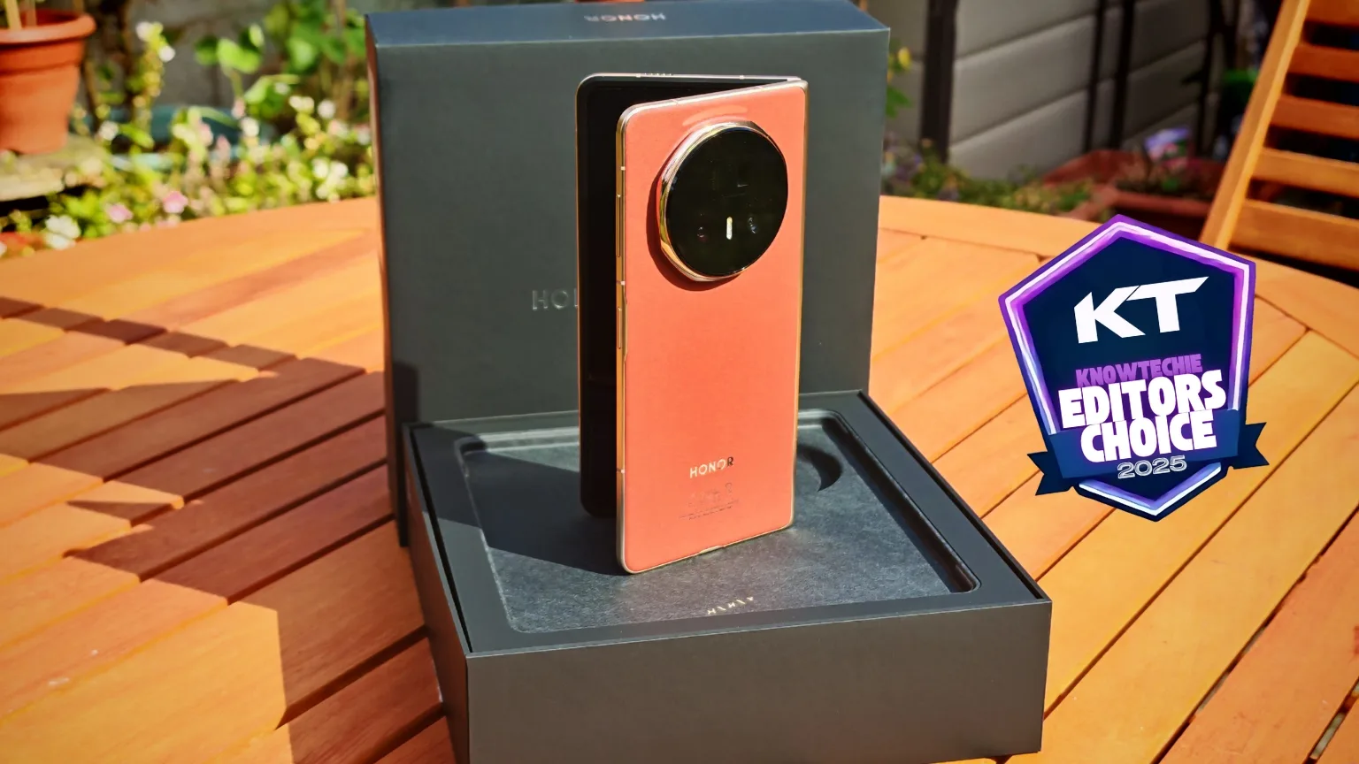 High-end Honor smartphone with a distinctive circular camera module, presented outdoors on a wooden table, showcasing innovative mobile device design and cutting-edge technology.