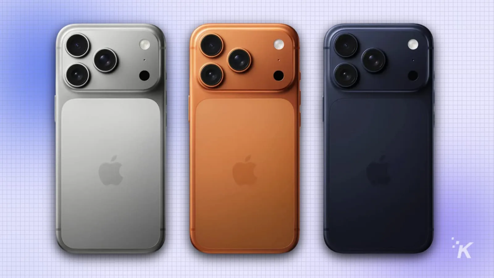 Three iPhones in silver, orange, and navy colors.