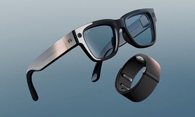 Smart glasses and wristband on blue background.