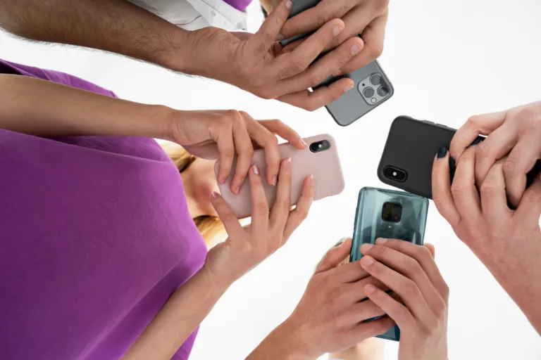 Close-up of multiple people holding and using smartphones, highlighting the latest mobile technology and smartphone camera features.