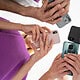 Close-up of multiple people holding and using smartphones, highlighting the latest mobile technology and smartphone camera features.