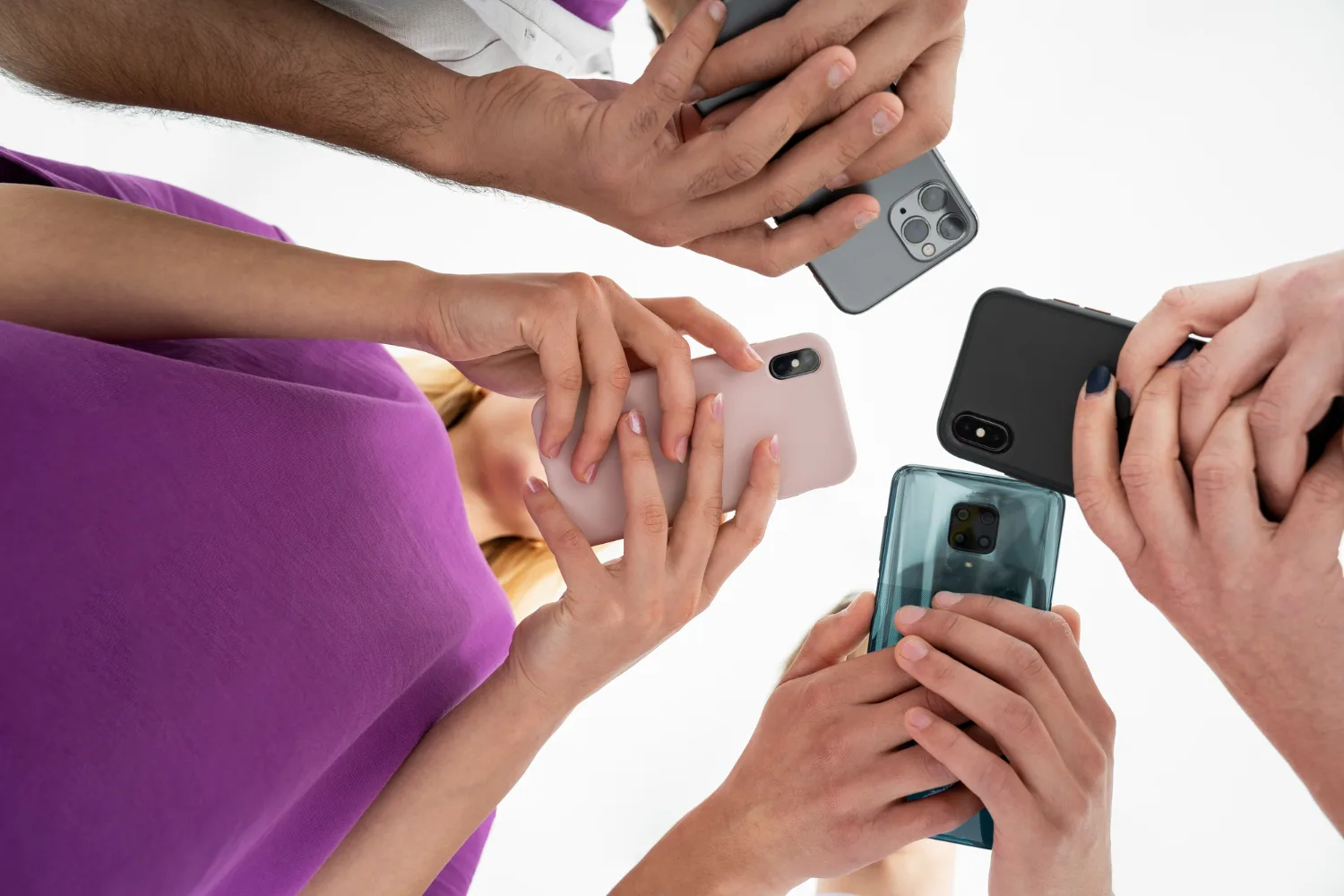 Close-up of multiple people holding and using smartphones, highlighting the latest mobile technology and smartphone camera features.