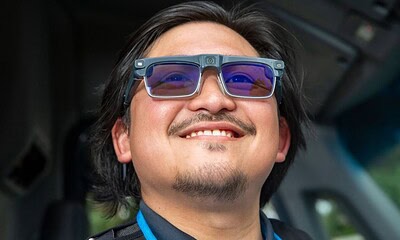 Men wearing augmented reality glasses, smiling, technology, AR glasses, wearable tech, innovation, future tech, smart glasses, virtual reality, tech accessories.