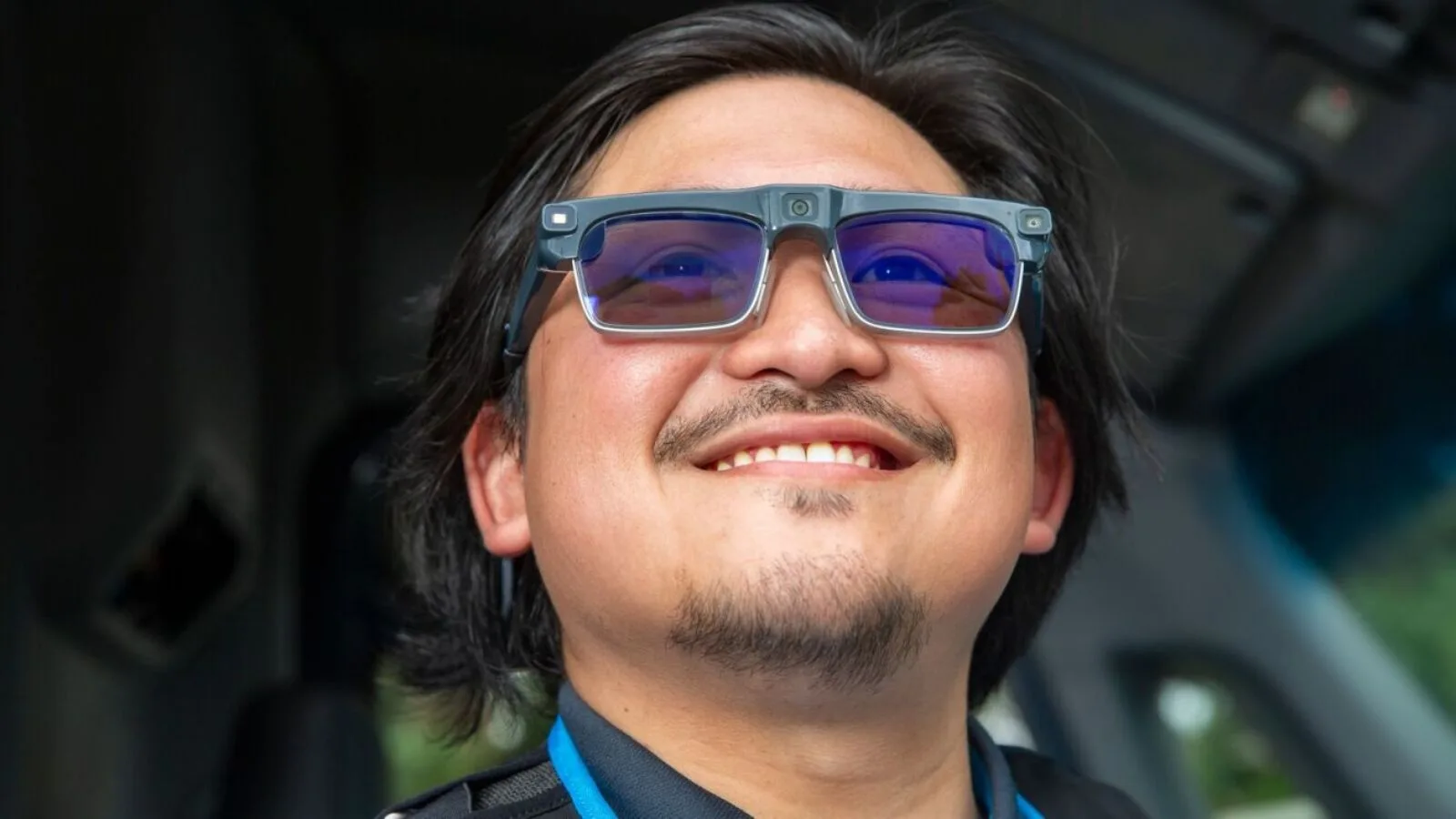 Men wearing augmented reality glasses, smiling, technology, AR glasses, wearable tech, innovation, future tech, smart glasses, virtual reality, tech accessories.