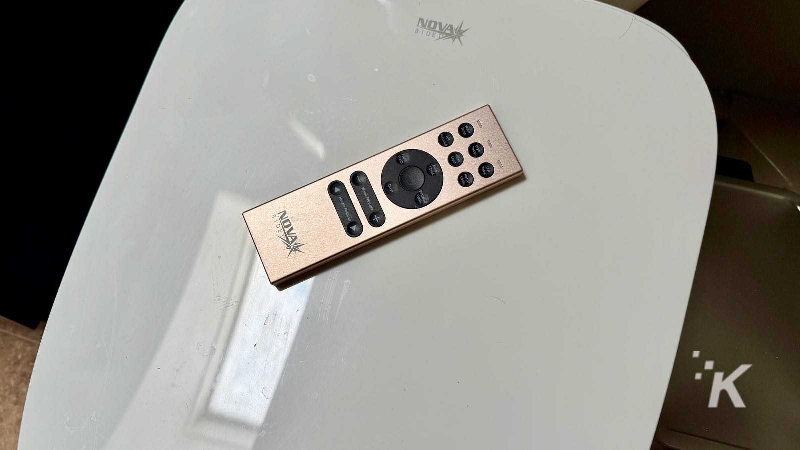 Gold remote control on white table