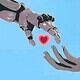 Futuristic robotic hand reaching out to human hand with heart symbol against bright blue sky background.