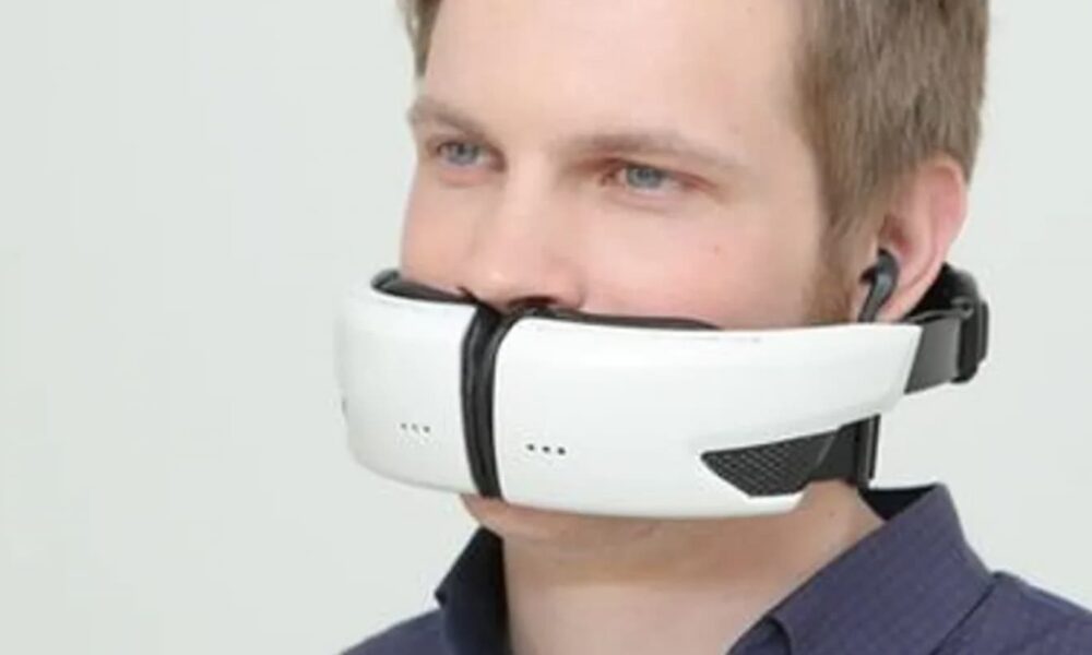 Wireless virtual reality headset for immersive gaming experiences, worn by a young man with blue eyes and short blond hair, connected with earphones for enhanced audio.