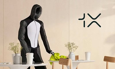 Futuristic robot in casual setting with plants and coffee cups, showcasing AI technology integration and innovation in robotics, highlighting advancements in AI-powered humanoid robots.