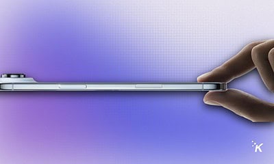 Sleek modern smartphone with a slim profile, held between fingers against a gradient purple background. Perfect for showcasing new mobile device design and technology features.