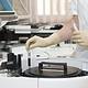 High-tech laboratory scientist handling blood samples using automated medical diagnostic equipment in a medical research facility.