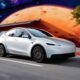 Futuristic white electric car driving past a vibrant mural featuring space and planetary artwork.