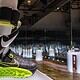 High-tech Nike smart running shoe with attached fitness tracker, displayed in a futuristic exhibit at KnowTechie showcasing innovative wearable technology.