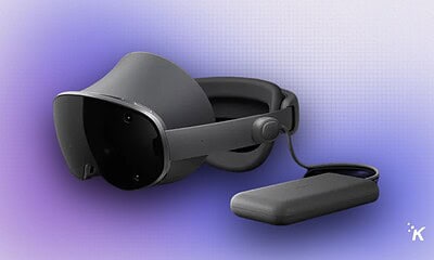 Virtual reality headset with attachment on a purple gradient background.