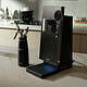 Nitrogen coffee infuser with XBREW branding on a kitchen countertop, modern and sleek device for nitrogen-infused beverages, with a small nitrogen bottle nearby in a bright, contemporary kitchen setting.