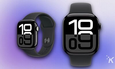 Smartwatch with large digital display, black band, and sleek design on a purple gradient background, showcasing wearable technology in modern health and fitness tracking.