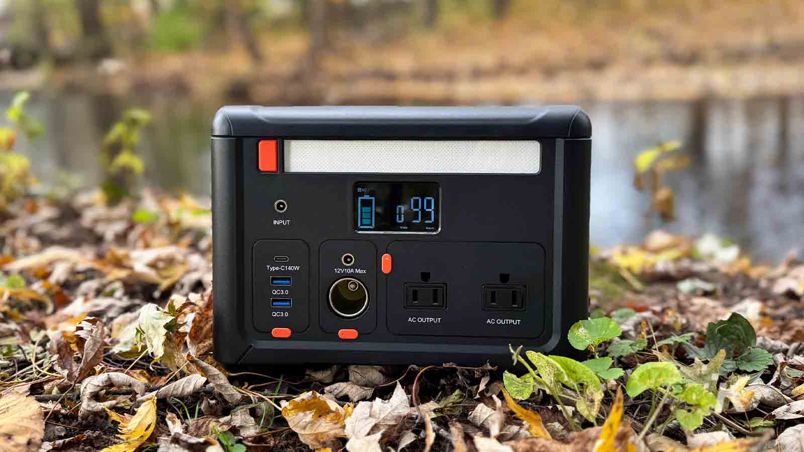 Portable power station in autumn leaves outdoors