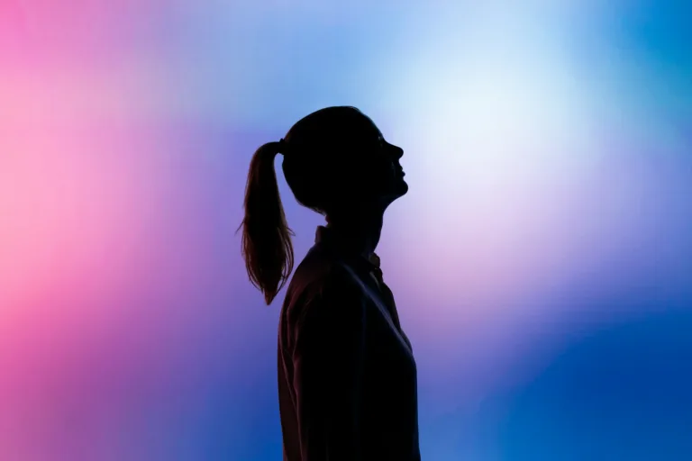 Silhouette of a woman with a ponytail against vibrant pink and blue gradient background, emphasizing technology, innovation, and modern lifestyle themes for SEO optimization.