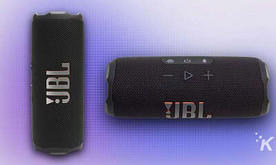 Wireless JBL portable speakers in black with textured surface, featuring Bluetooth controls and JBL logo, ideal for outdoor music, travel, and sound experience enhancement.