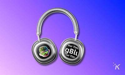 Wireless headphones with digital display and custom graphic design on earpieces, set against a vibrant purple-blue gradient background.