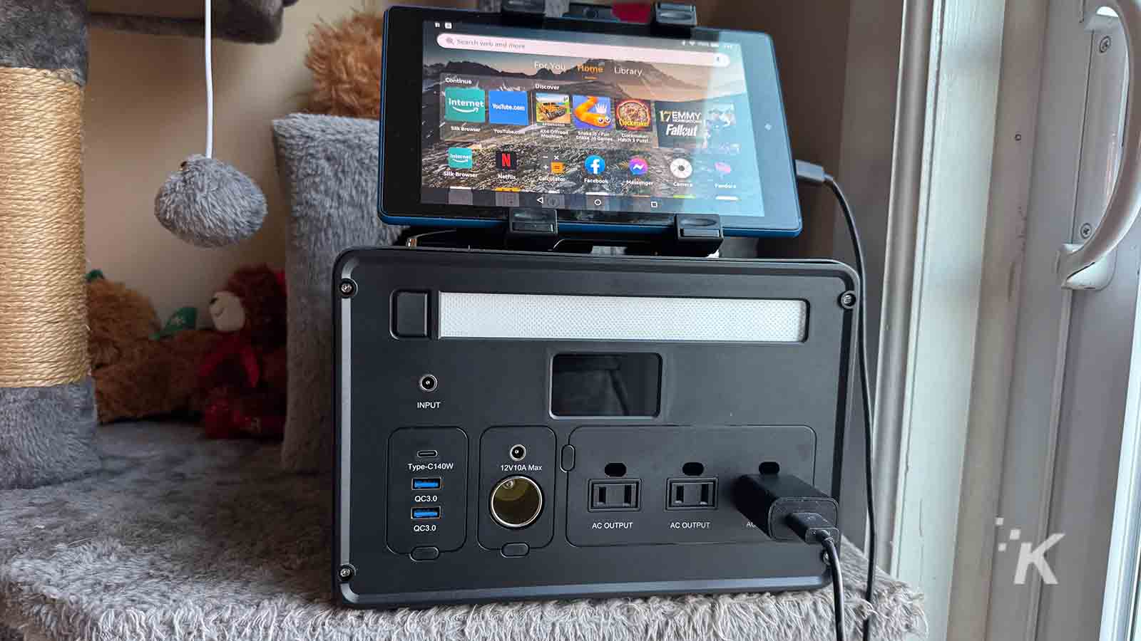 Tablet connected to portable power station on shelf