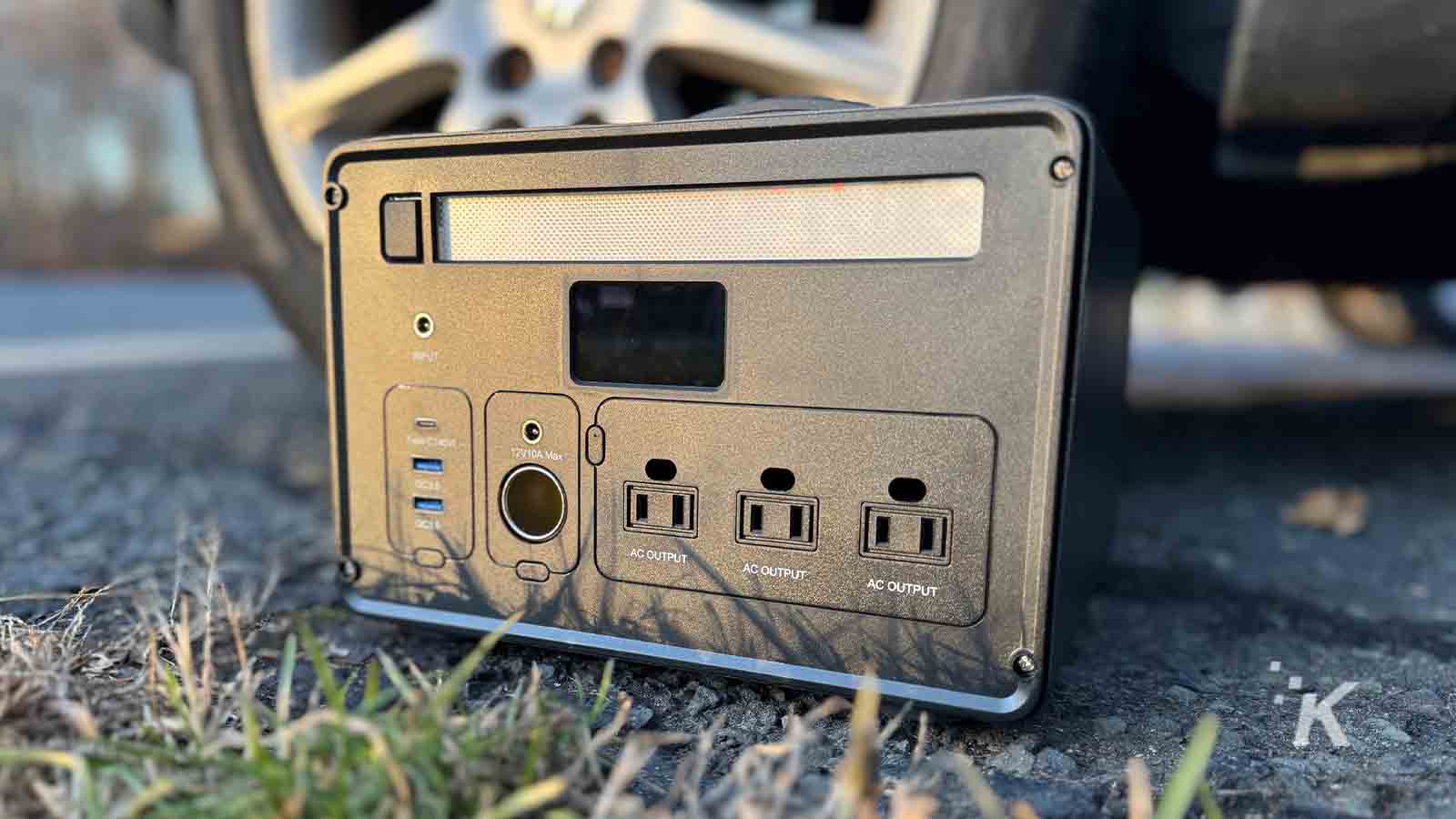 Portable power station next to a car wheel