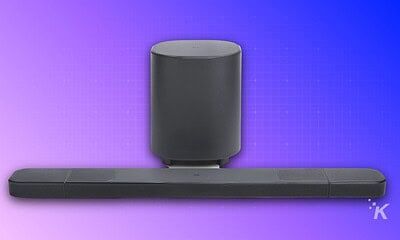 Elegant black sound system with tall subwoofer and long soundbar, ideal for home theater setups and enhancing TV sound quality.