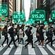 A busy city crosswalk filled with pedestrians on their smartphones, with futuristic digital price tags floating above the street, illustrating urban technology and digital innovations in daily life.