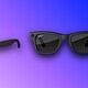 Black Ray-Ban sunglasses with dark lenses showcased on colorful gradient backdrop.