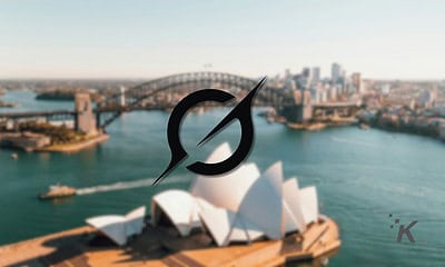 Sydney Opera House and Harbour Bridge viewed from the water, with a compass icon indicating travel, navigation, or landmarks in Australia.
