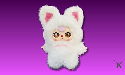 Cute plush toy with a bunny hoodie and anime-style face, vibrant large eyes, and a pink nose. Perfect for kawaii collectors and fans of adorable, whimsical plushies.