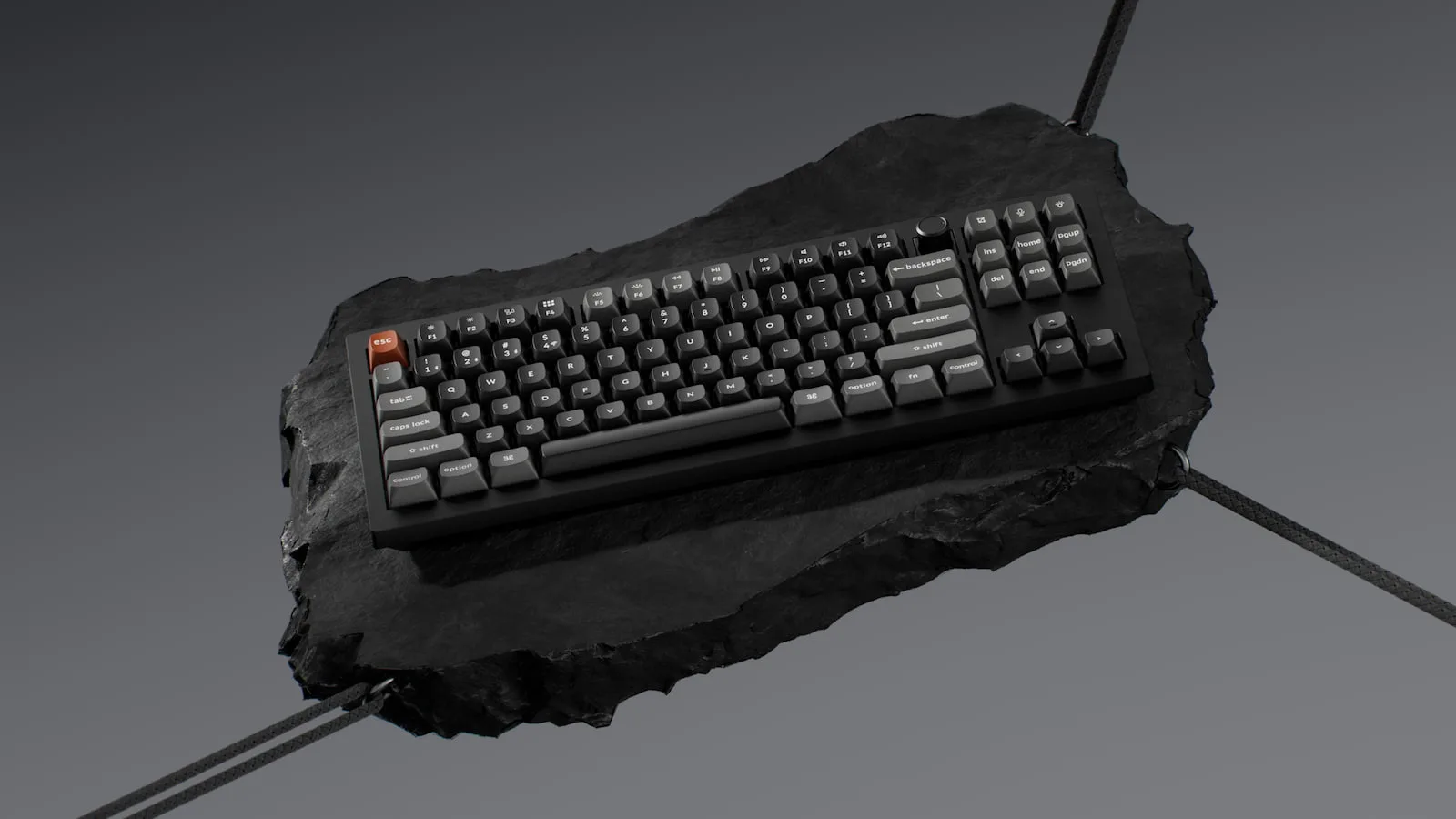 Floating mechanical Keychron keyboard on dark stone surface.