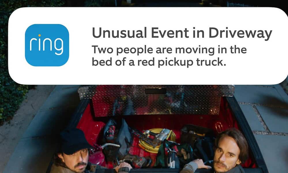 Ring notification alert capturing unexpected activity in driveway with two individuals in a truck bed.