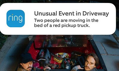 Ring notification alert capturing unexpected activity in driveway with two individuals in a truck bed.